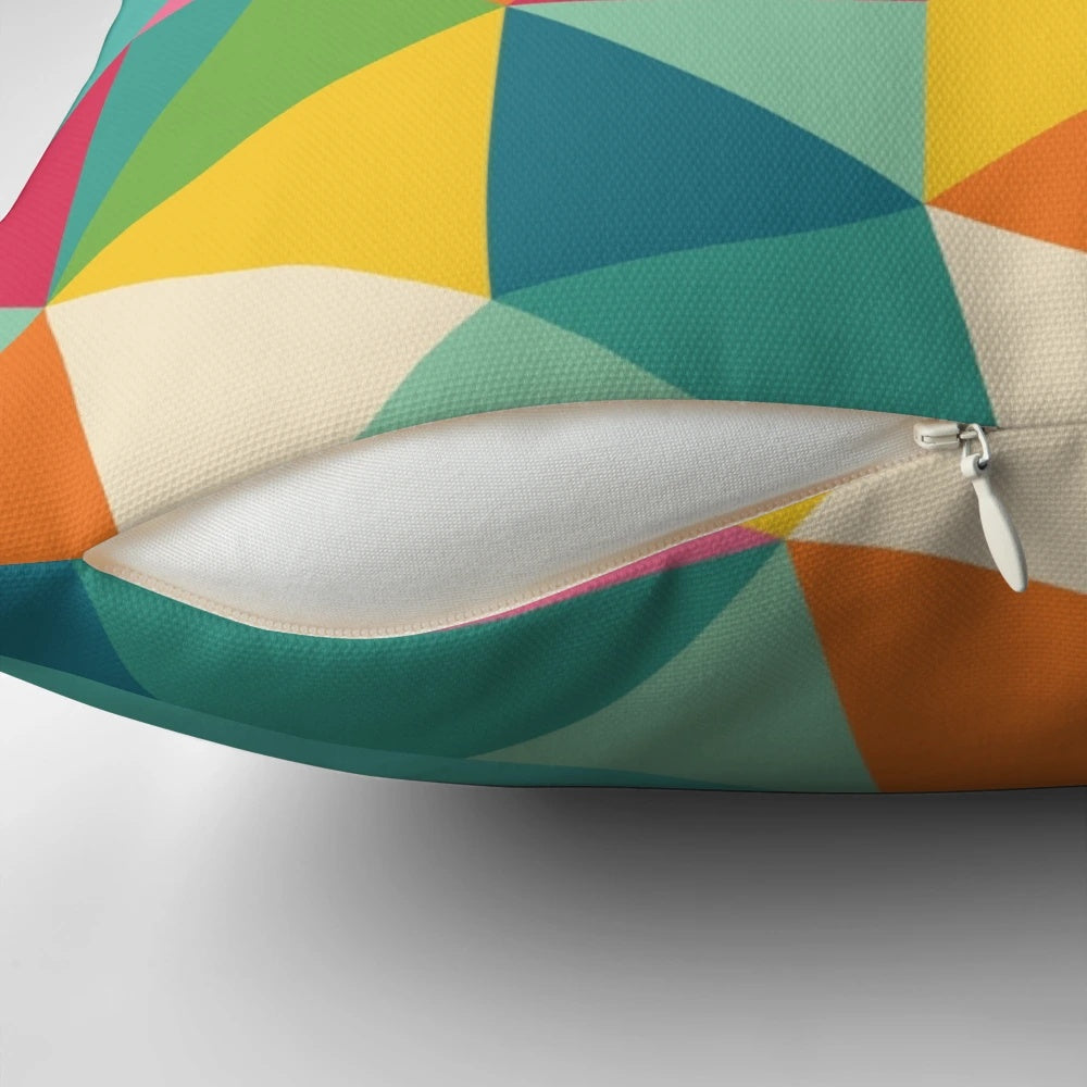 A vibrant, geometric-patterned pillow depicting a sloth surfing a wave