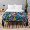 Plush blanket with abstract, colorful graffiti-style hearts and city wall pattern