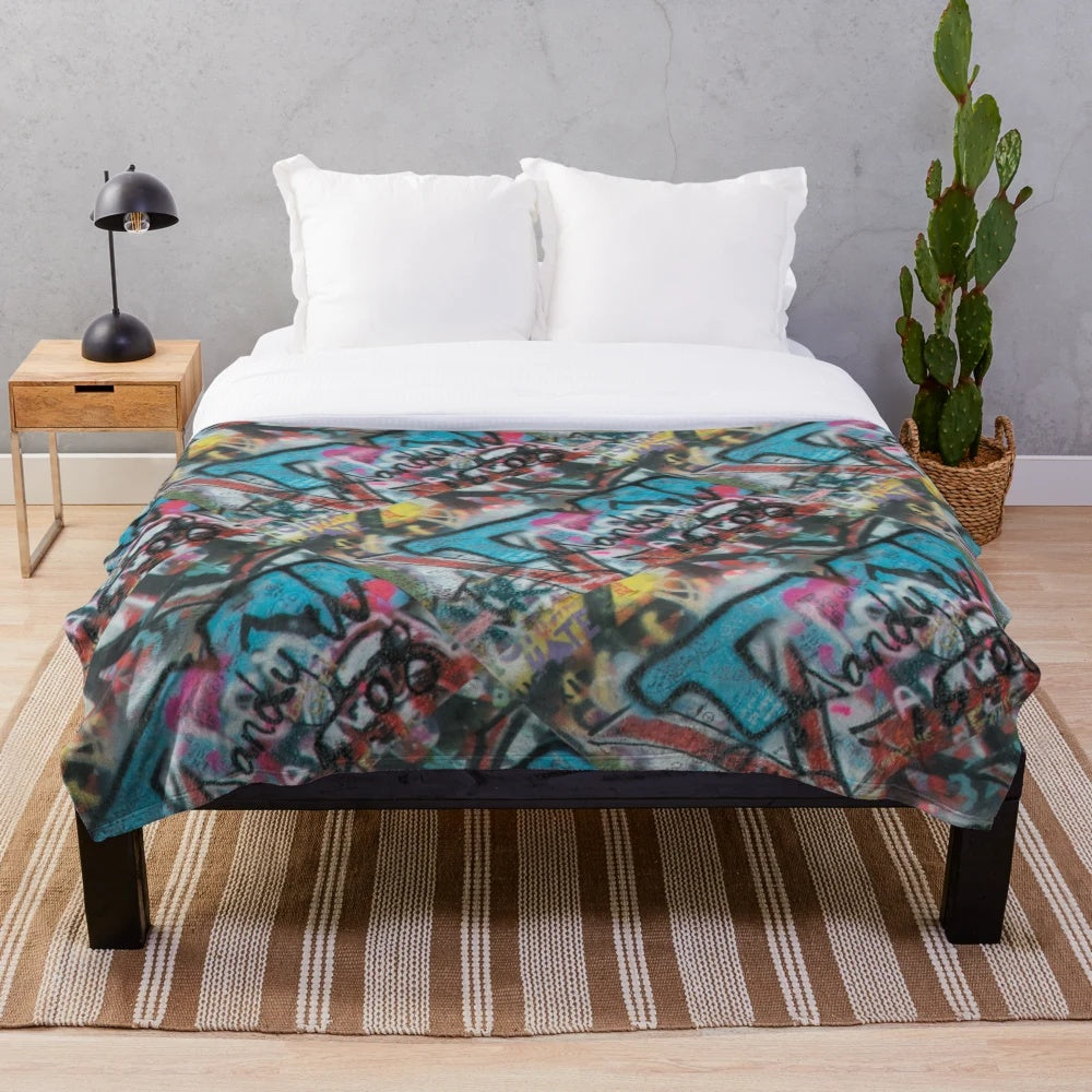 Graffiti pattern plush blanket with abstract, vibrant colors and urban style