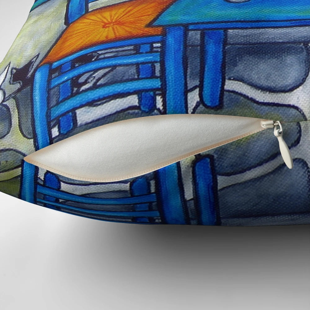 Vibrant Greek-inspired decorative pillow featuring a table and chairs in a taverna setting