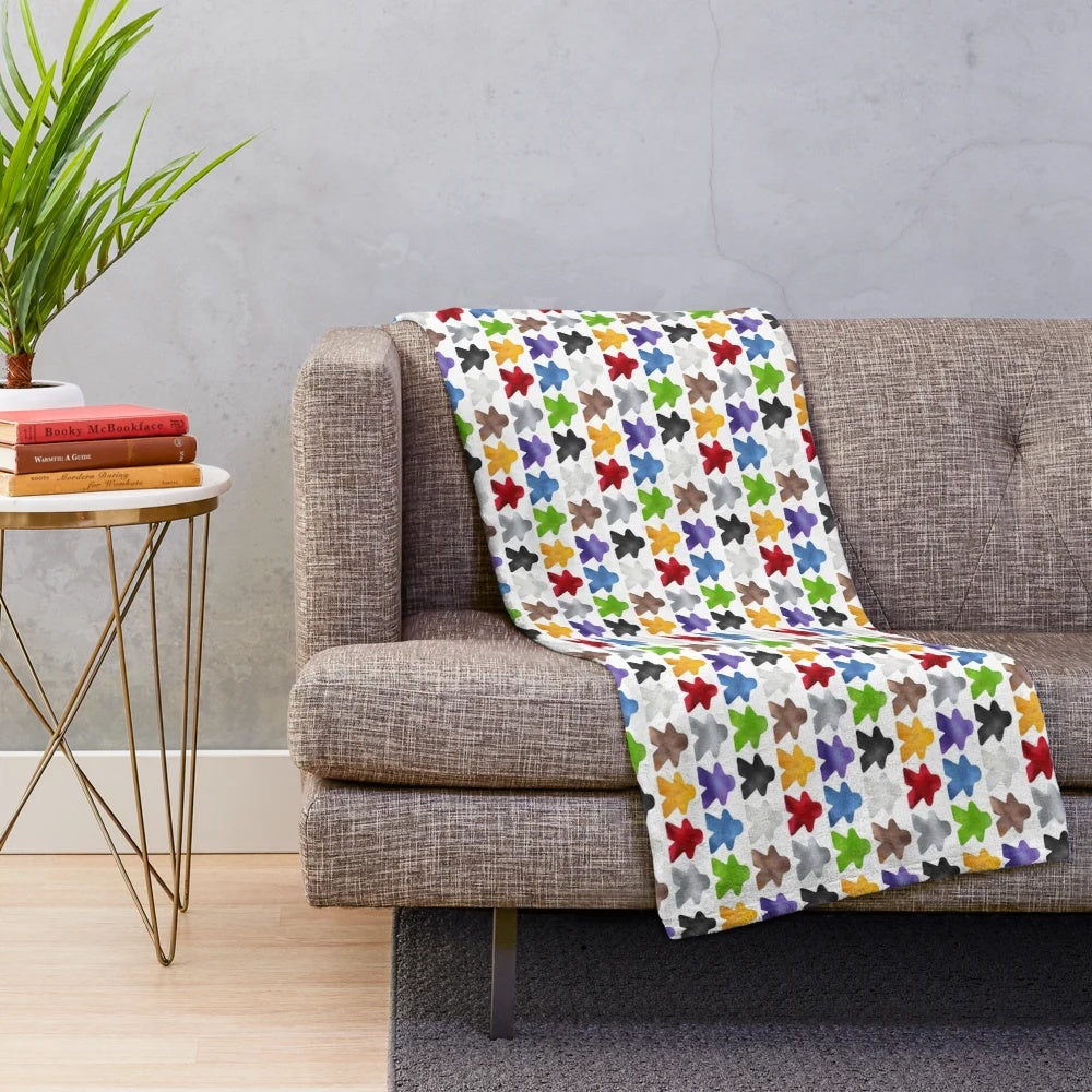 Cozy plush blanket featuring a colorful meeple design for board game enthusiasts