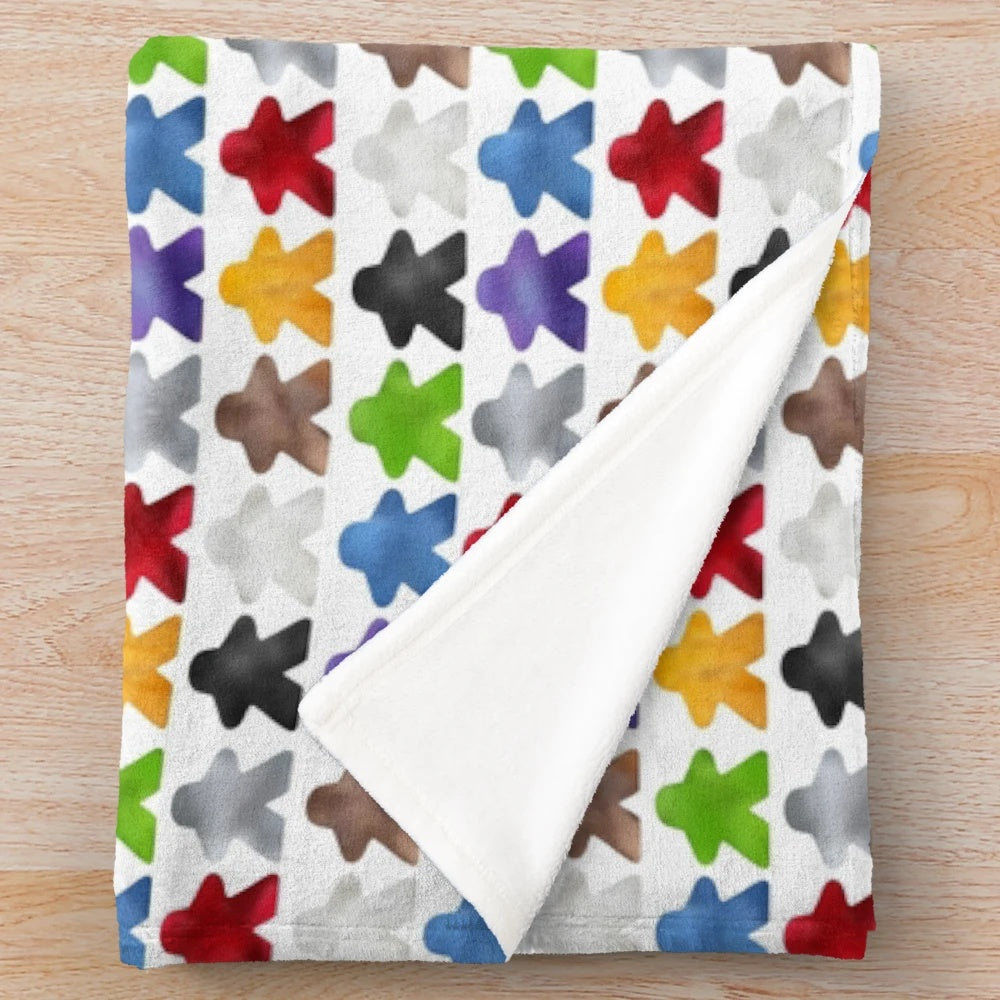 Cozy plush blanket featuring a colorful meeple design for board game enthusiasts