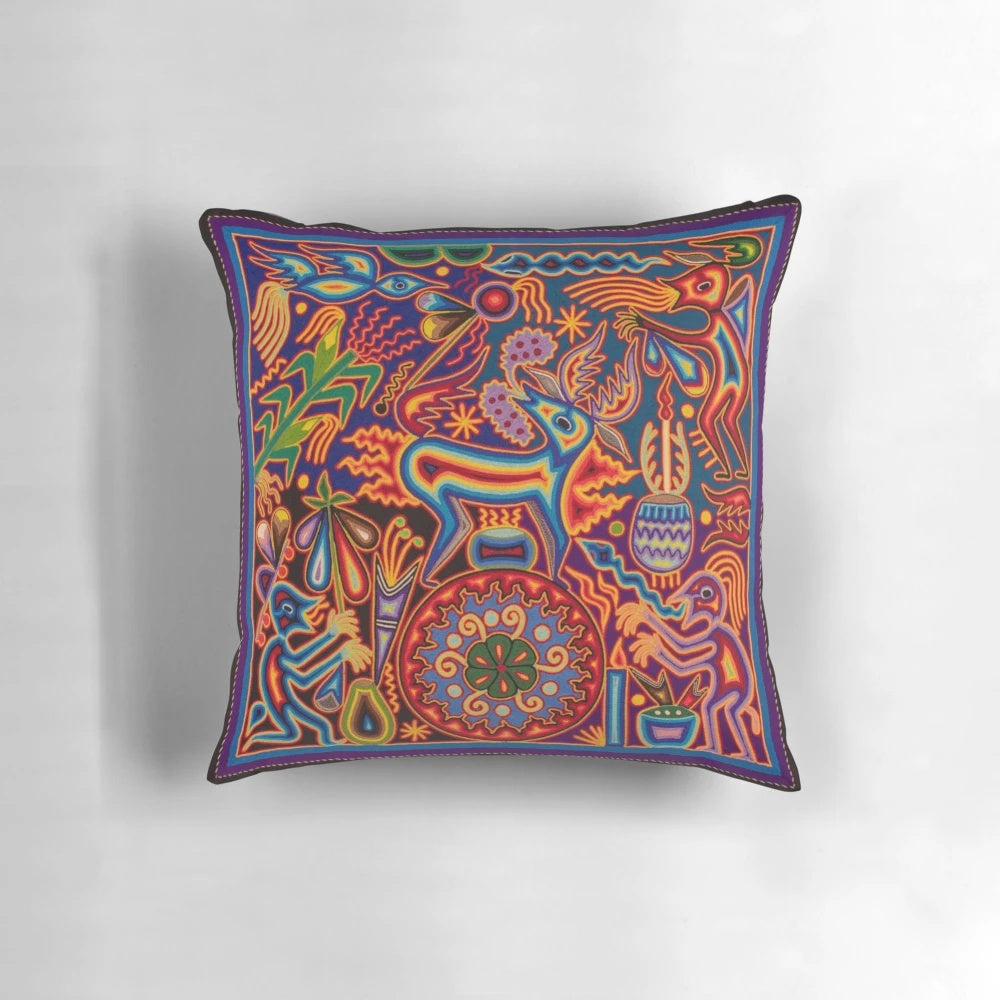Vibrant, abstract floral and skull-patterned pillow in shades of red, black, and white