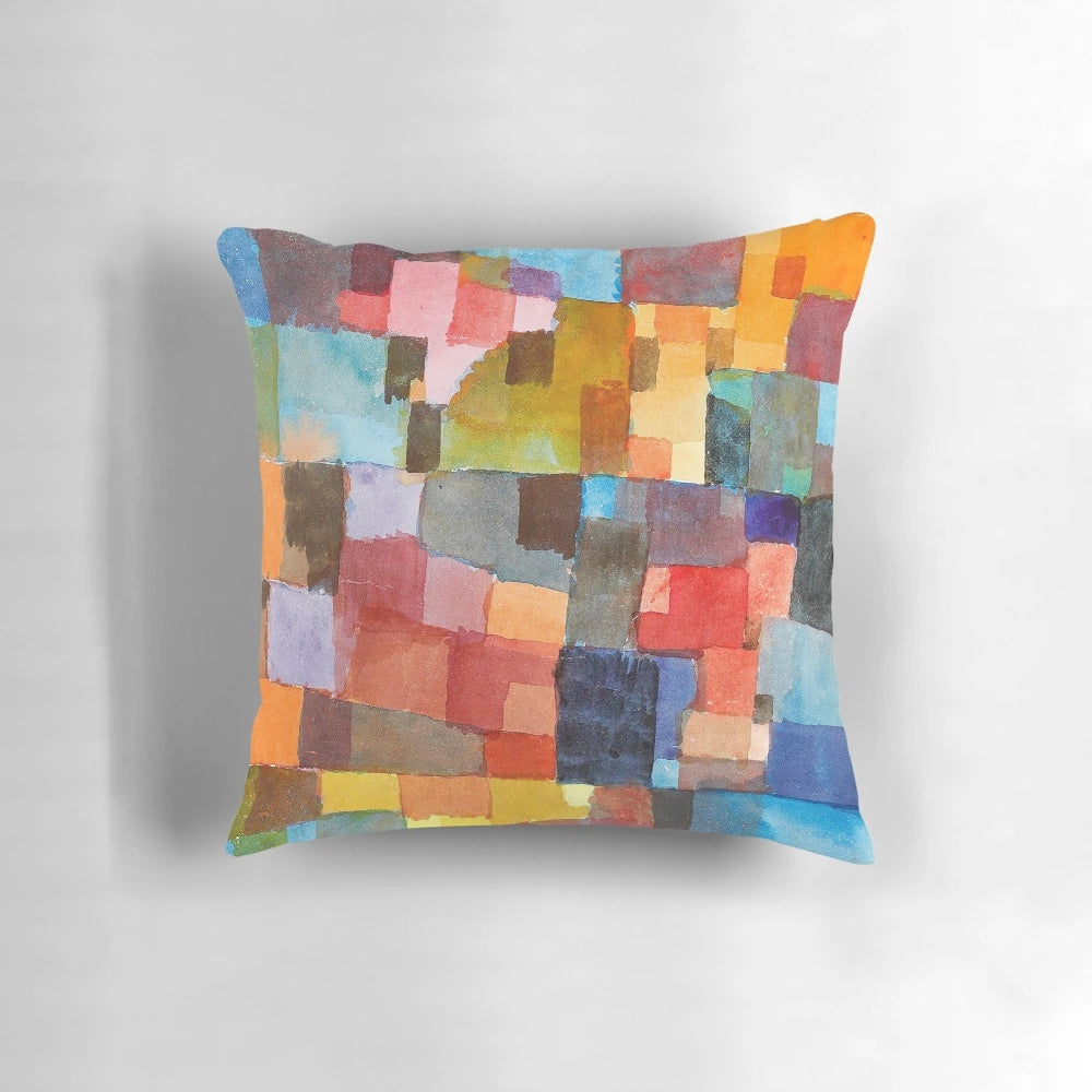 Colorful decorative pillow featuring abstract architectural design in the style of artist Paul Klee