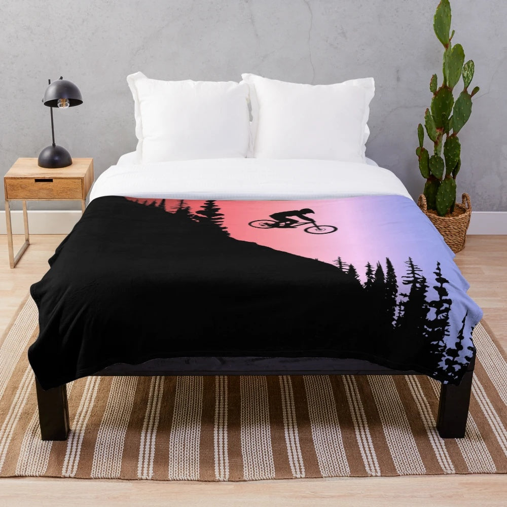 Colorful plush blanket featuring mountain bike-inspired design