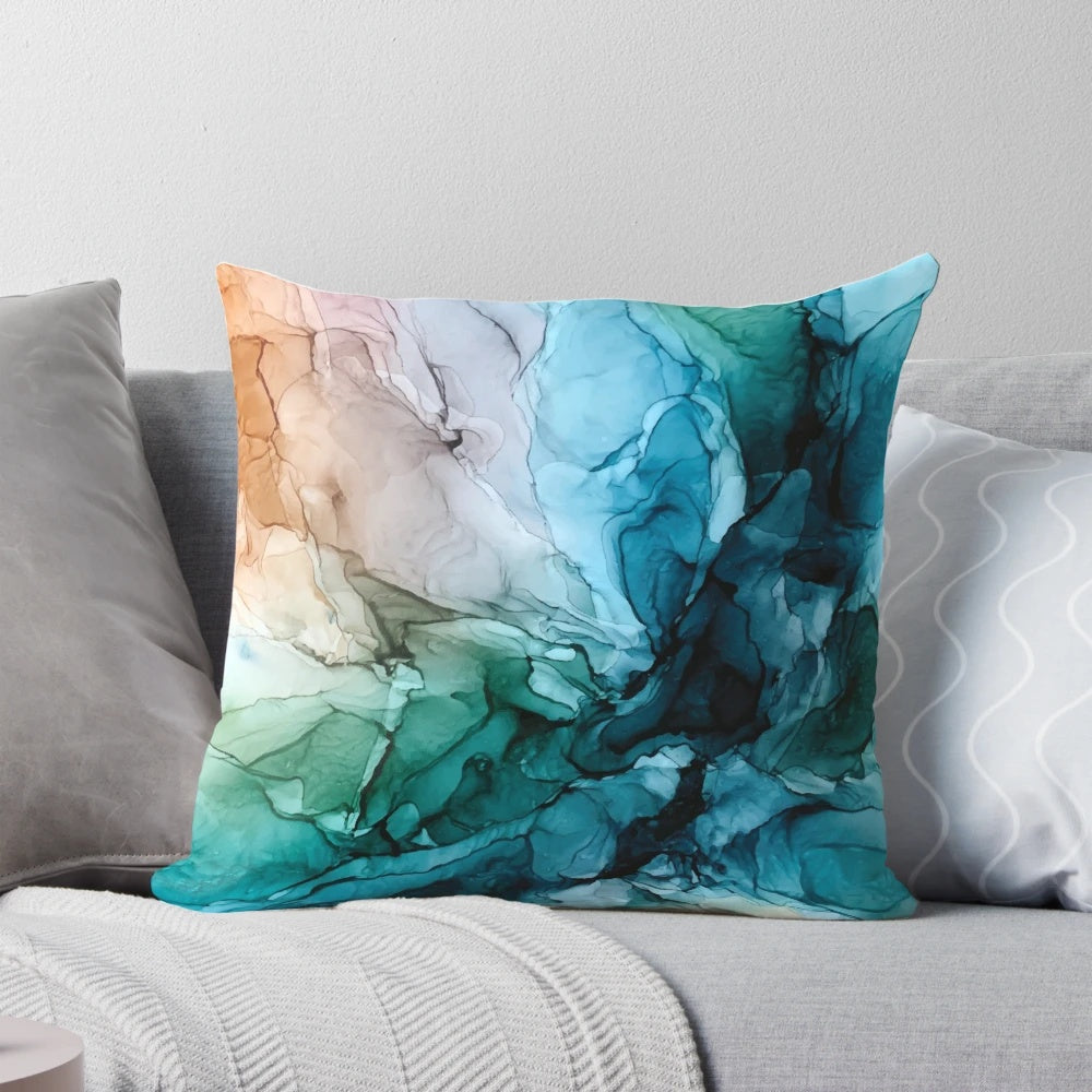 Vibrant abstract painting in shades of blue and orange on a decorative throw pillow, perfect for ocean-themed home decor.