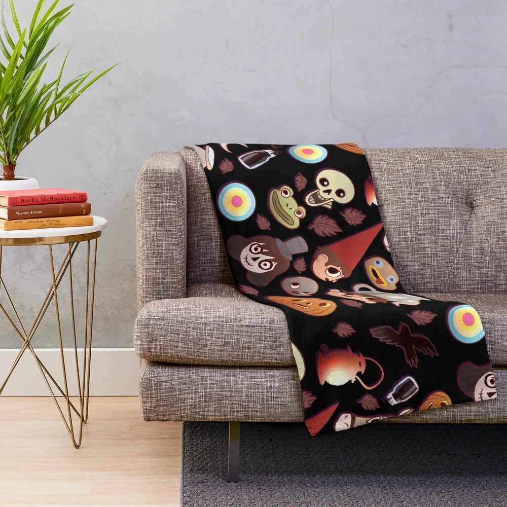 Colorful plush blanket featuring the characters and patterns from the animated show Over the Garden Wall