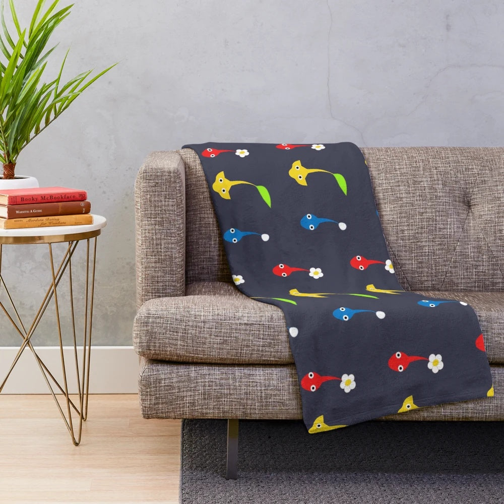 Vibrant Pikmin characters plush blanket featuring red, blue, and yellow Pikmin