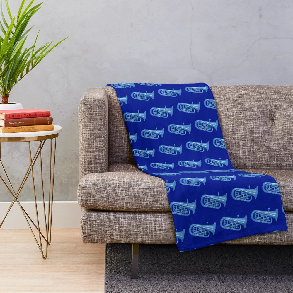 Blue plush blanket with musical instruments like baritone, euphonium, and tuba
