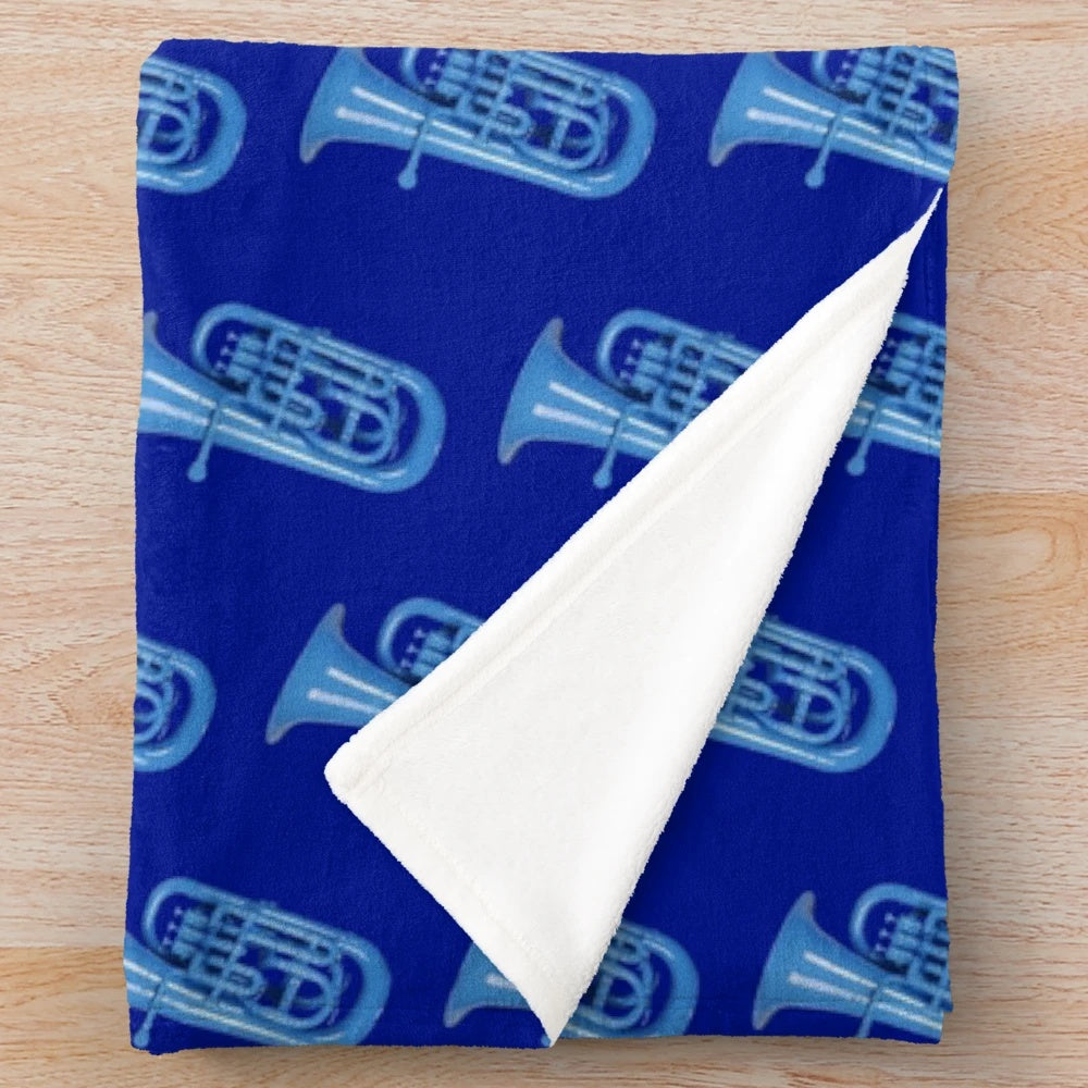 Blue plush blanket with musical instruments like baritone, euphonium, and tuba