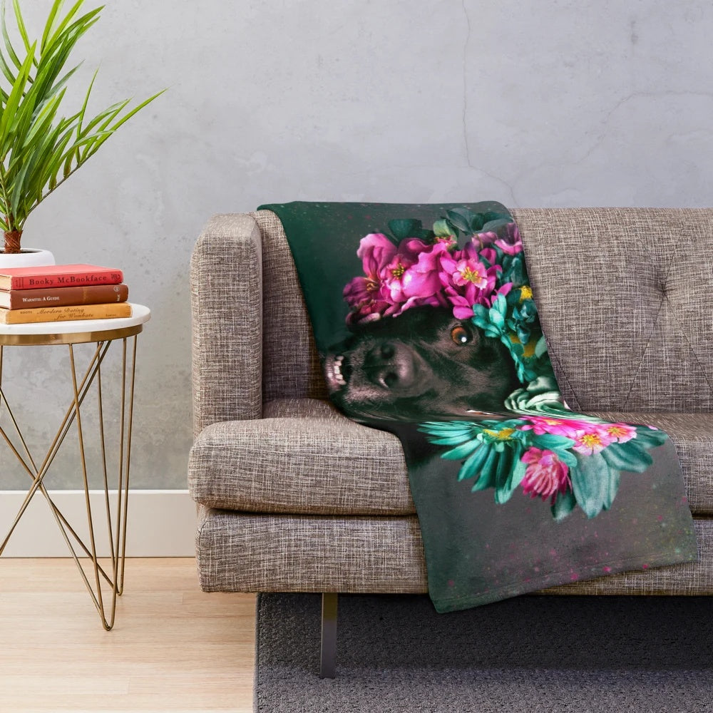 Plush blanket with vibrant floral designs and a happy pitbull