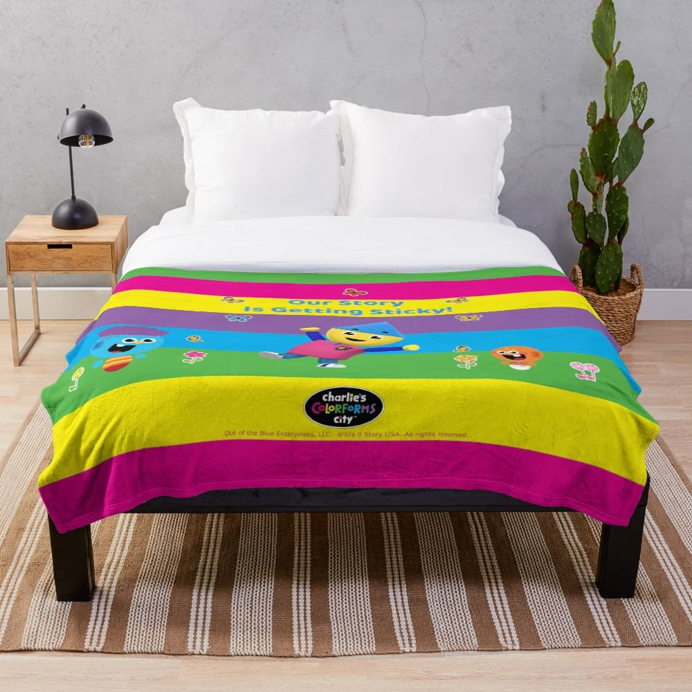 Colorful plush blanket featuring characters from Charlie's Colorforms City