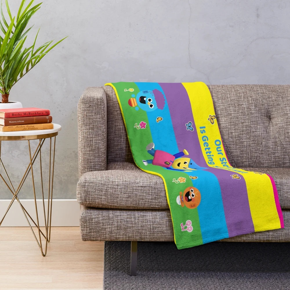 Colorful plush blanket featuring characters from Charlie's Colorforms City
