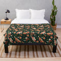 Colorful plush blanket with a pattern featuring moths, leaves, and flowers