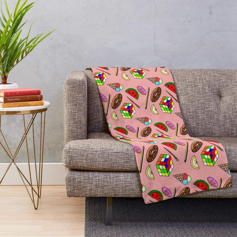 Colorful plush blanket featuring food and hobby patterns