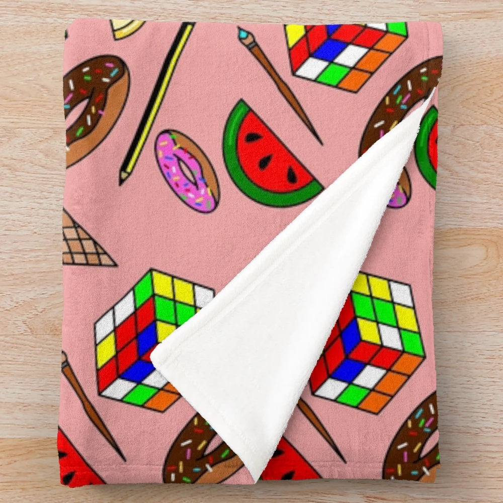 Colorful plush blanket featuring food and hobby patterns