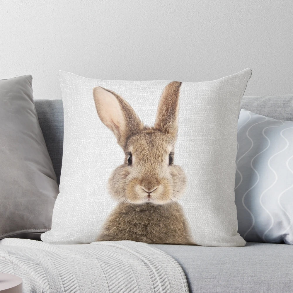 Colorful pillow featuring a rabbit or bunny illustration in a modern, minimalist style.