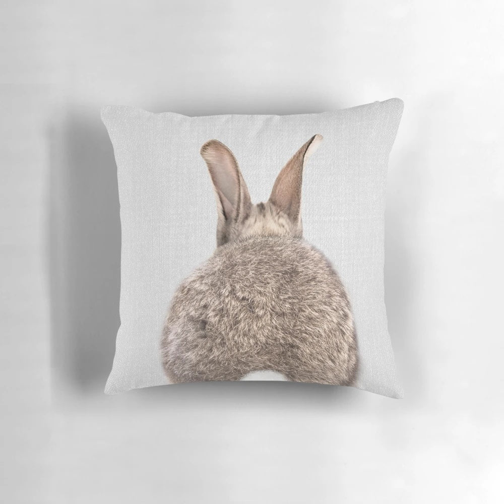 Colorful and whimsical decorative pillow featuring a rabbit's tail