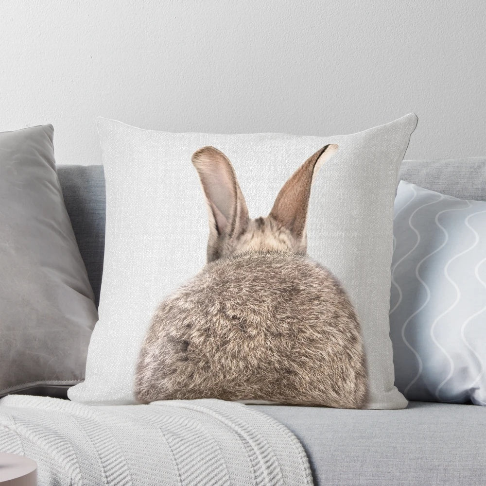 Colorful and whimsical decorative pillow featuring a rabbit's tail