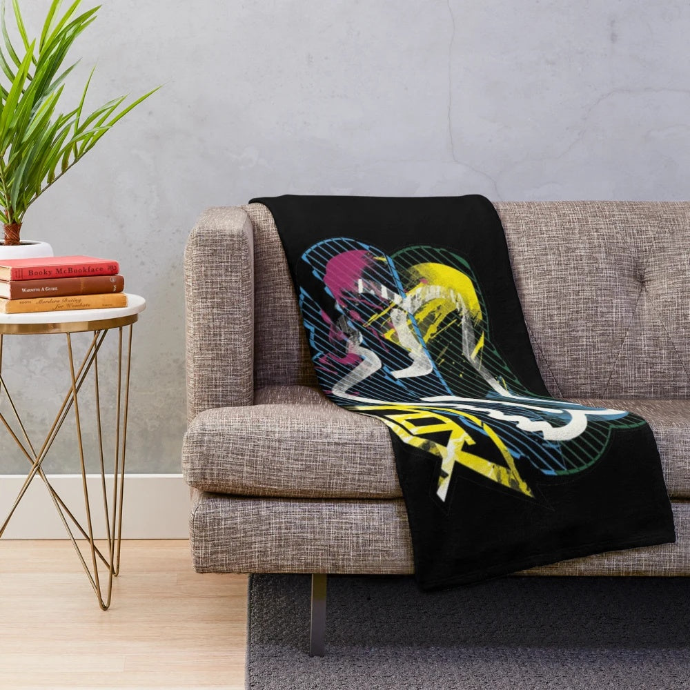 Colorful plush racing themed blanket with paint splatter design