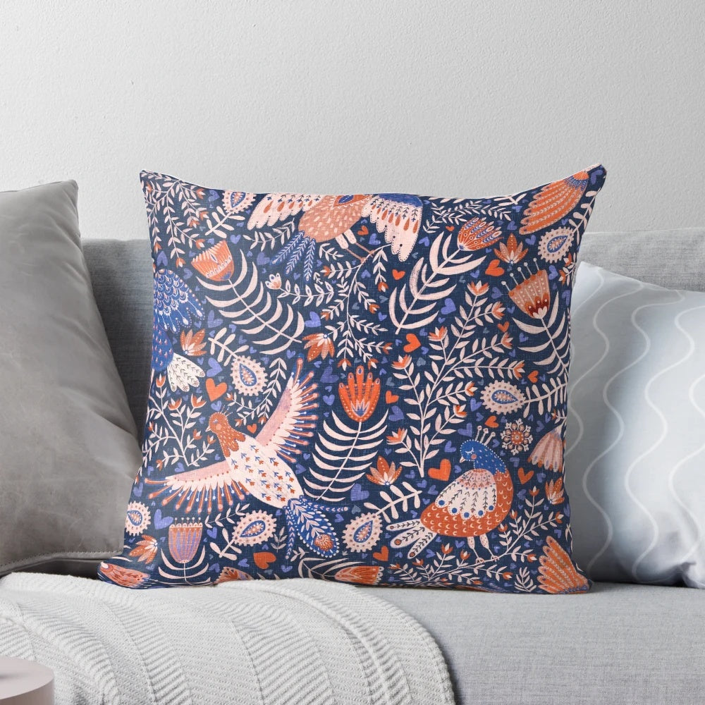 A throw pillow featuring a vibrant, patterned design of Swedish folk art birds against a dark blue background.
