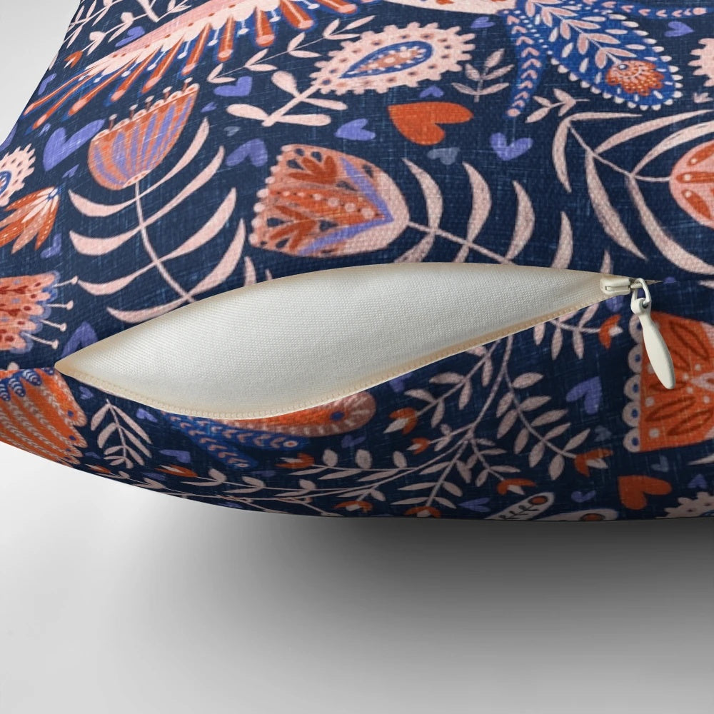 A throw pillow featuring a vibrant, patterned design of Swedish folk art birds against a dark blue background.