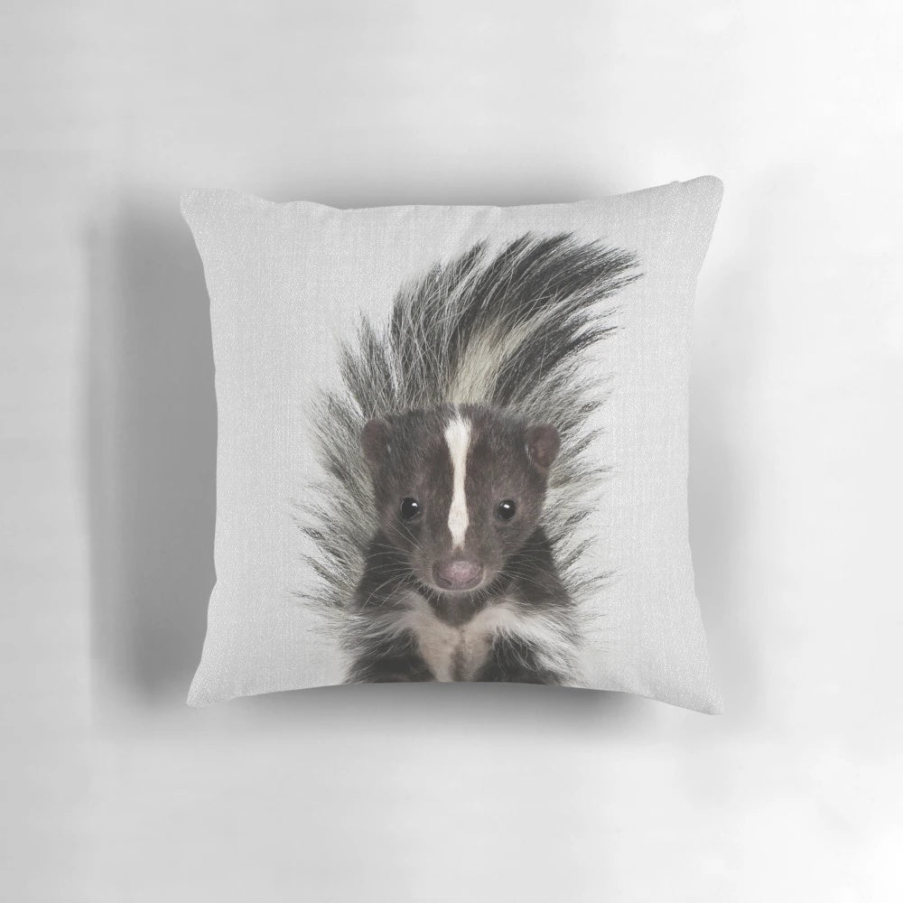Vibrant and whimsical pillow featuring a stylized skunk portrait in a modern, minimalist design.