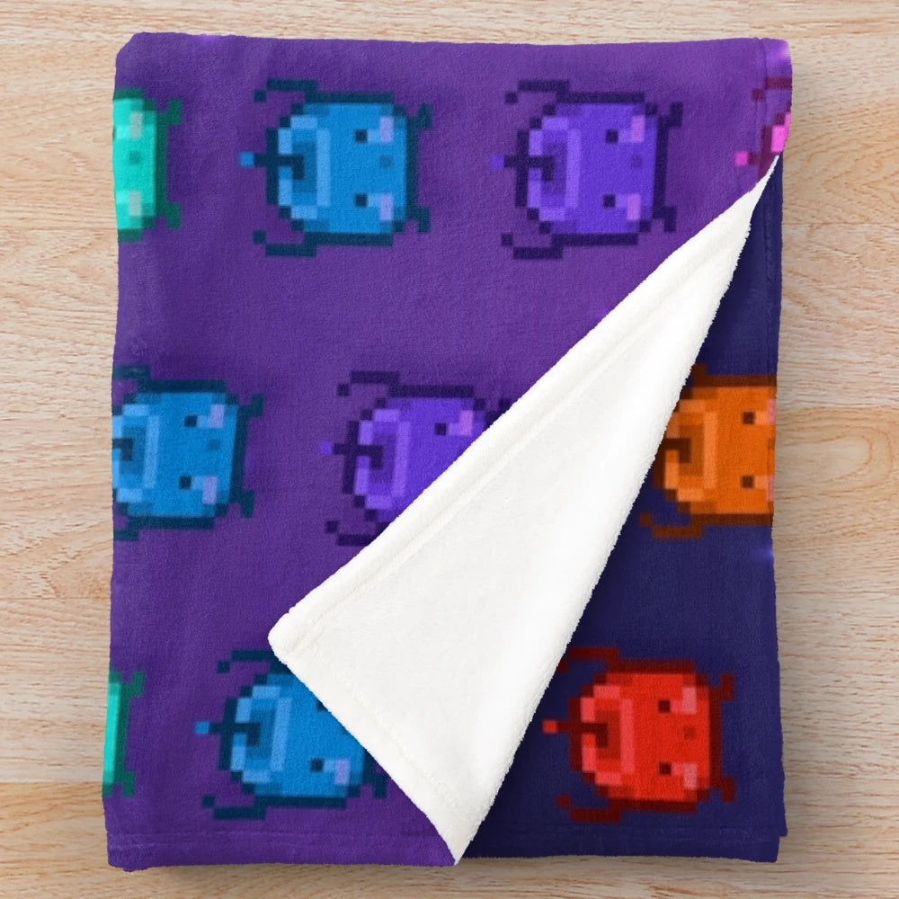 Stardew Valley Junimos Plush Blanket featuring a vibrant rainbow pattern