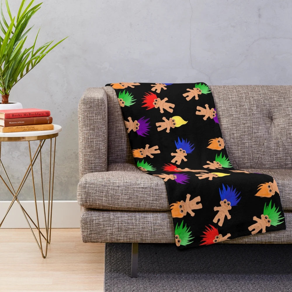 Colorful plush blanket with troll dolls pattern