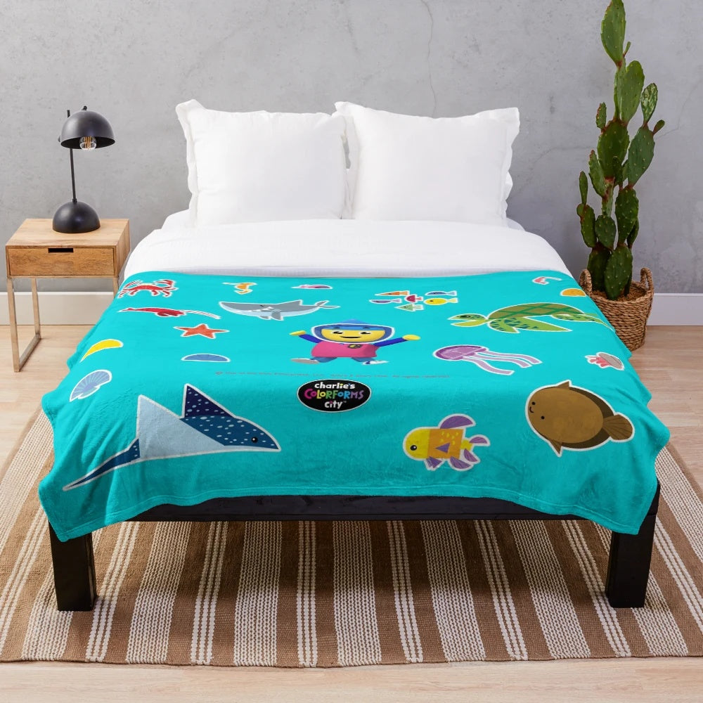 Plush blanket featuring an underwater scene with various sea creatures