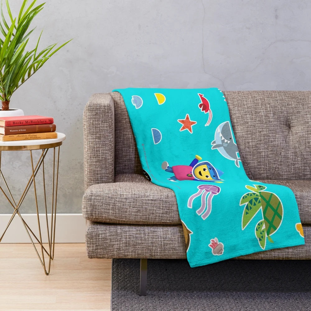 Plush blanket featuring an underwater scene with various sea creatures