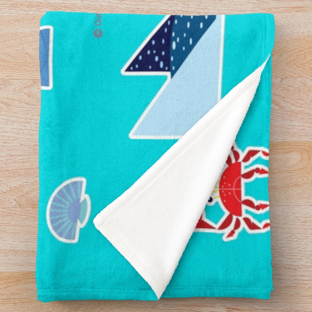 Plush blanket featuring an underwater scene with various sea creatures