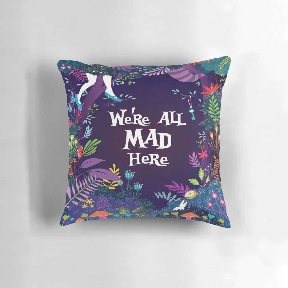 Colorful throw pillow featuring the quote "We're All Mad Here" from Alice in Wonderland