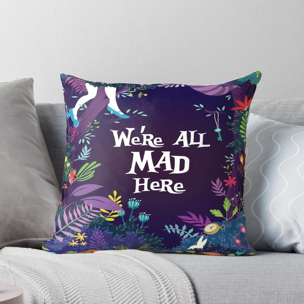 Colorful throw pillow featuring the quote "We're All Mad Here" from Alice in Wonderland