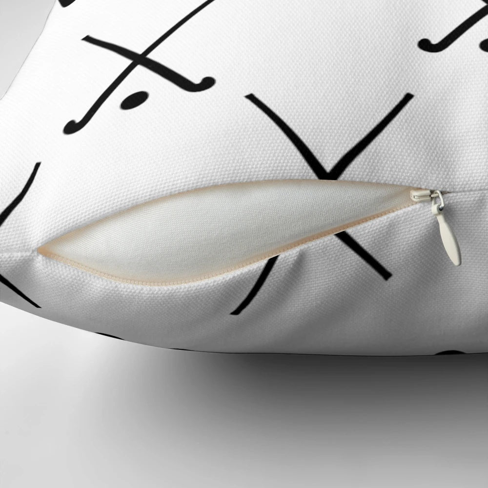 A plush field hockey-themed pillow featuring crossed hockey sticks against a green background.