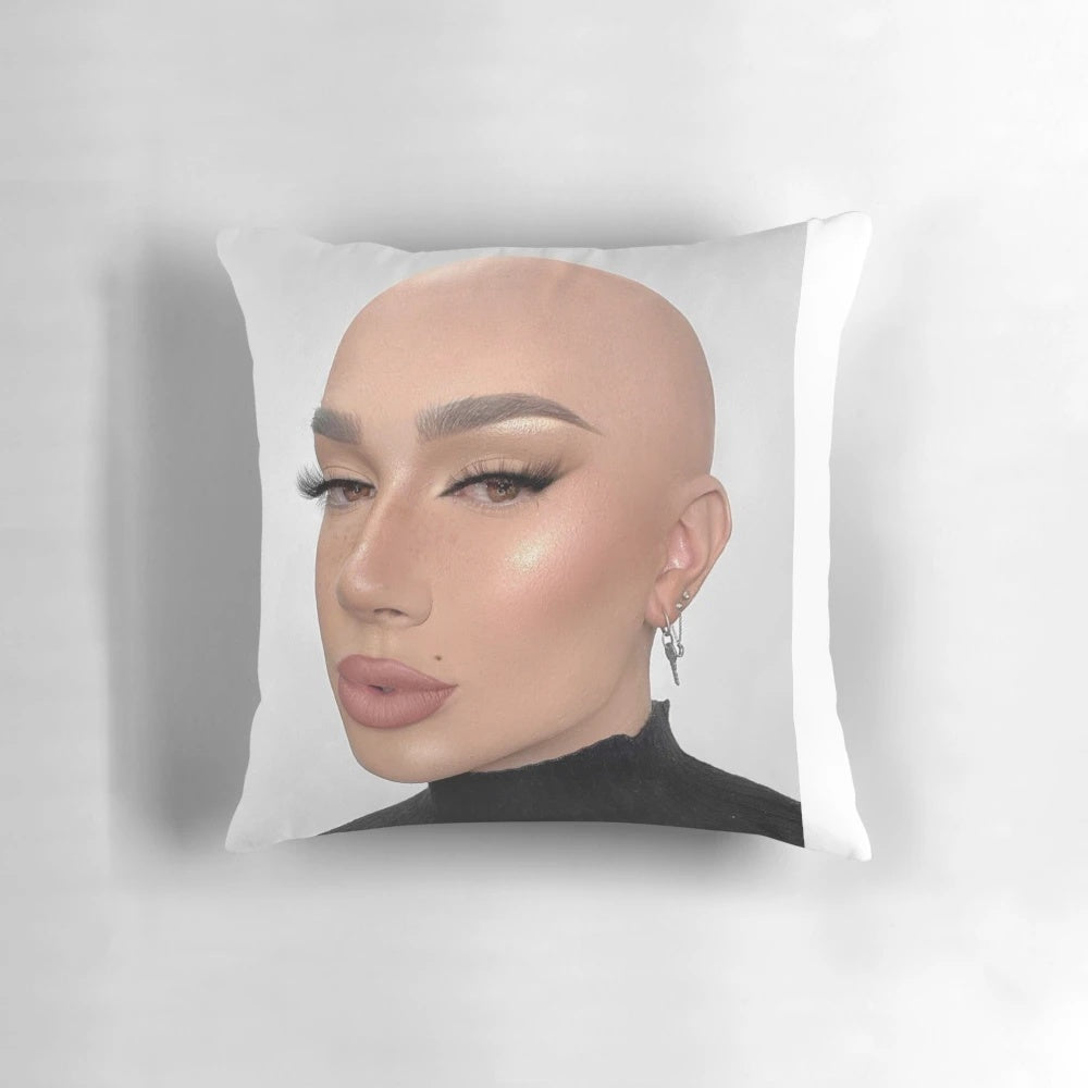 Closeup of a soft, white pillow with the James Charles logo printed on it.