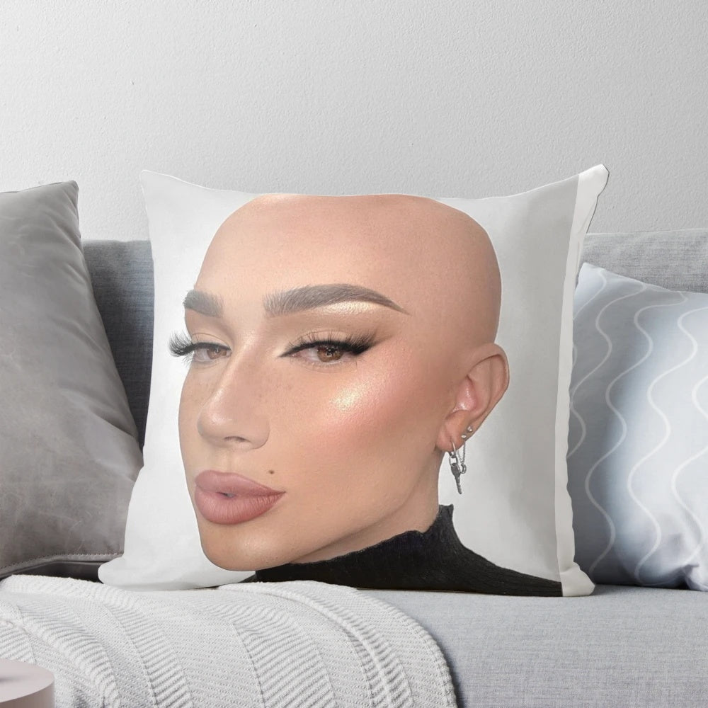 Closeup of a soft, white pillow with the James Charles logo printed on it.