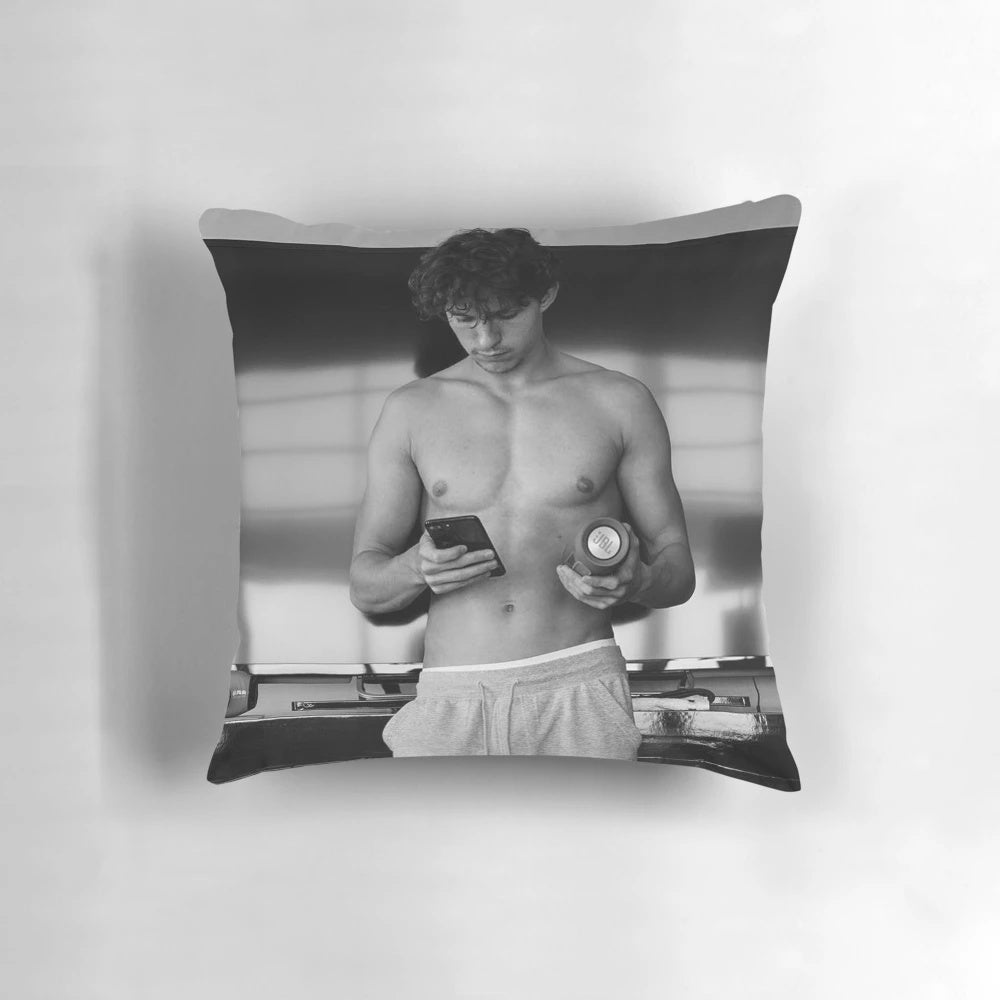 A plush pillow featuring the image of actor Tom Holland as Spider-Man.