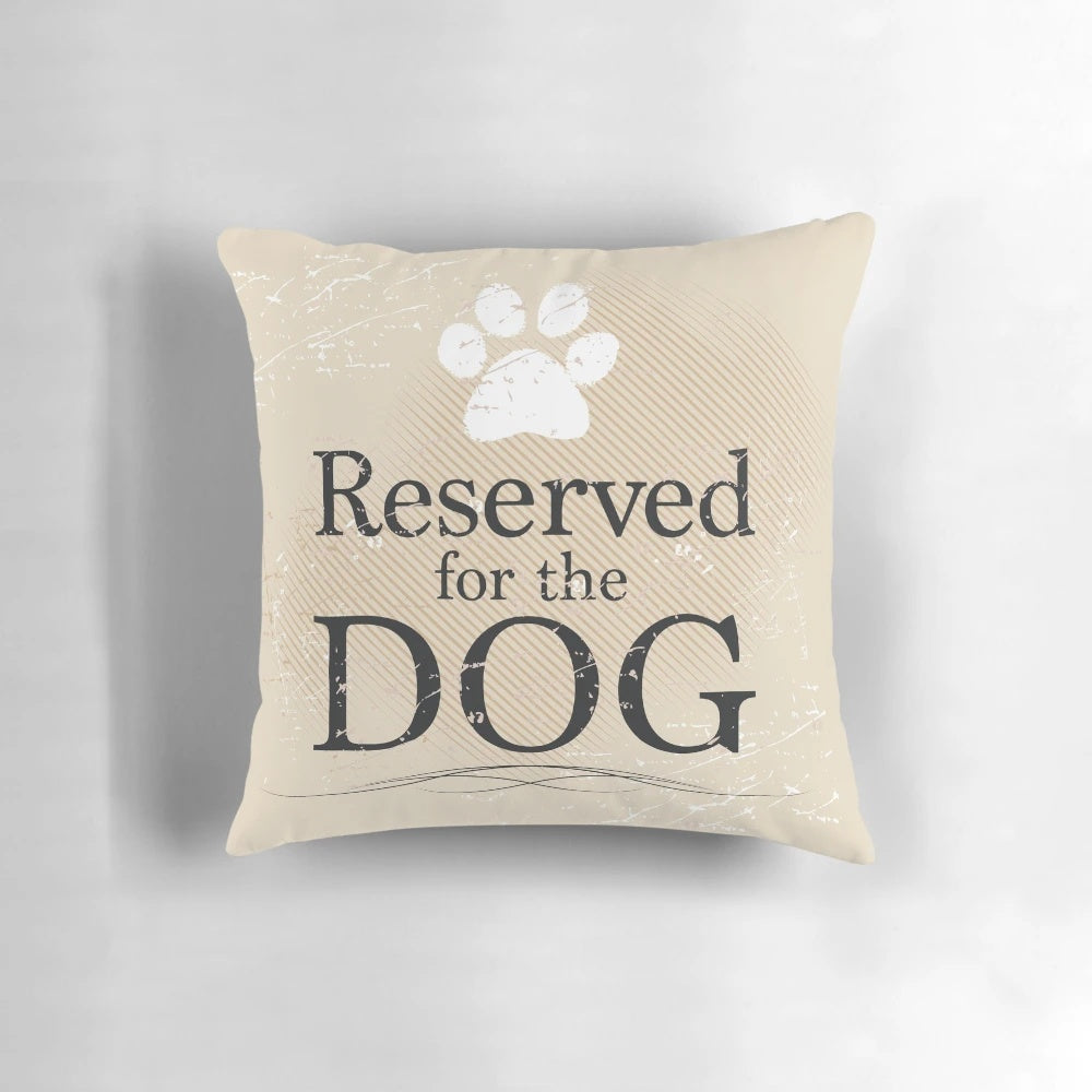 Tan pillow with the text "Reserved for the Dog" printed on it, perfect for dog owners and rescue pet supporters.