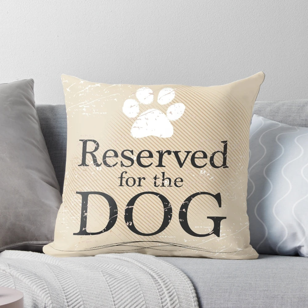 Tan pillow with the text "Reserved for the Dog" printed on it, perfect for dog owners and rescue pet supporters.