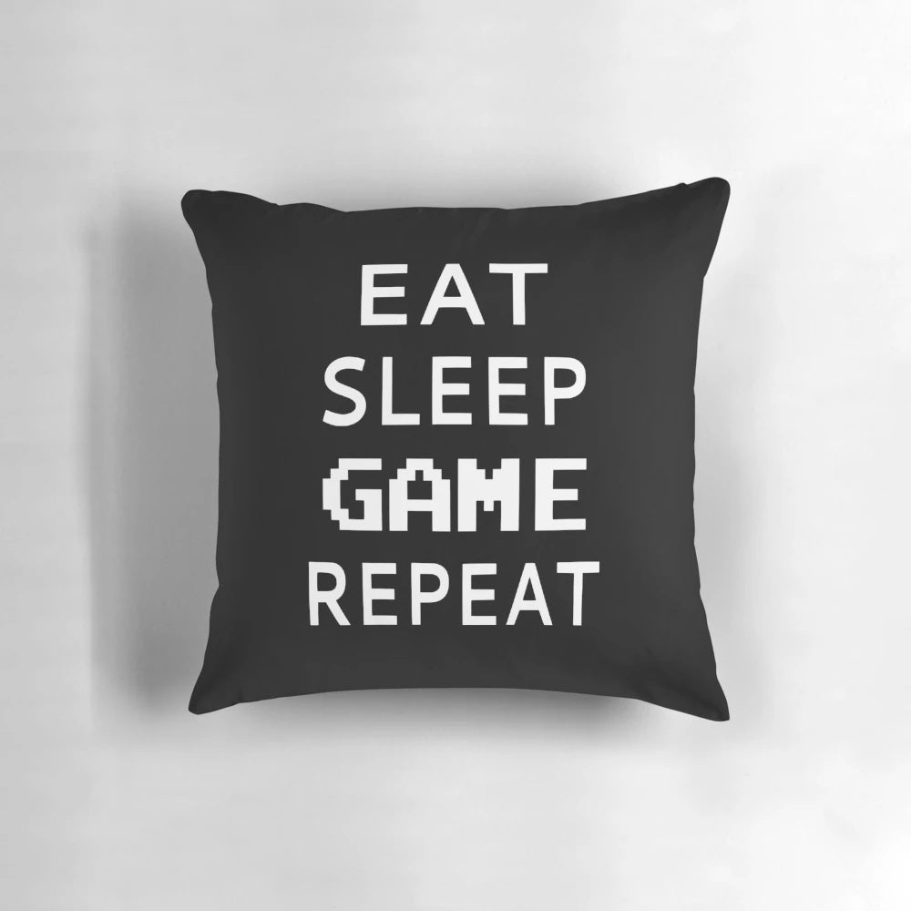 Soft, plush pillow with the text "Eat Sleep Game Repeat" for video game enthusiasts
