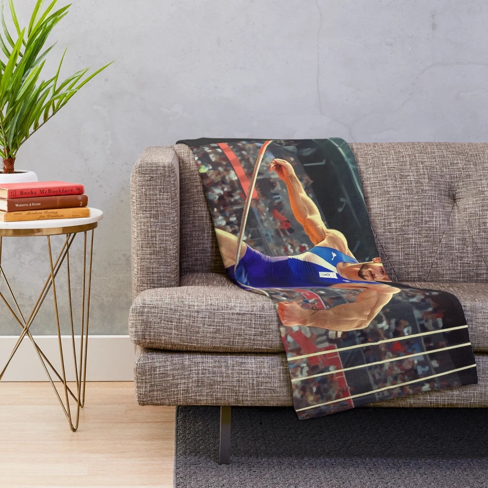 Plush blanket featuring a humorous pole vault mishap illustration