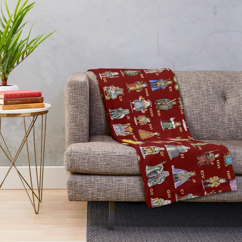 Plush blanket featuring illustrations of British monarchs throughout history
