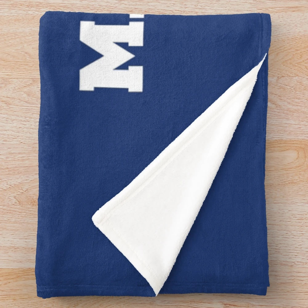 USMMA Mariners Plush Blanket featuring the school's logo and colors