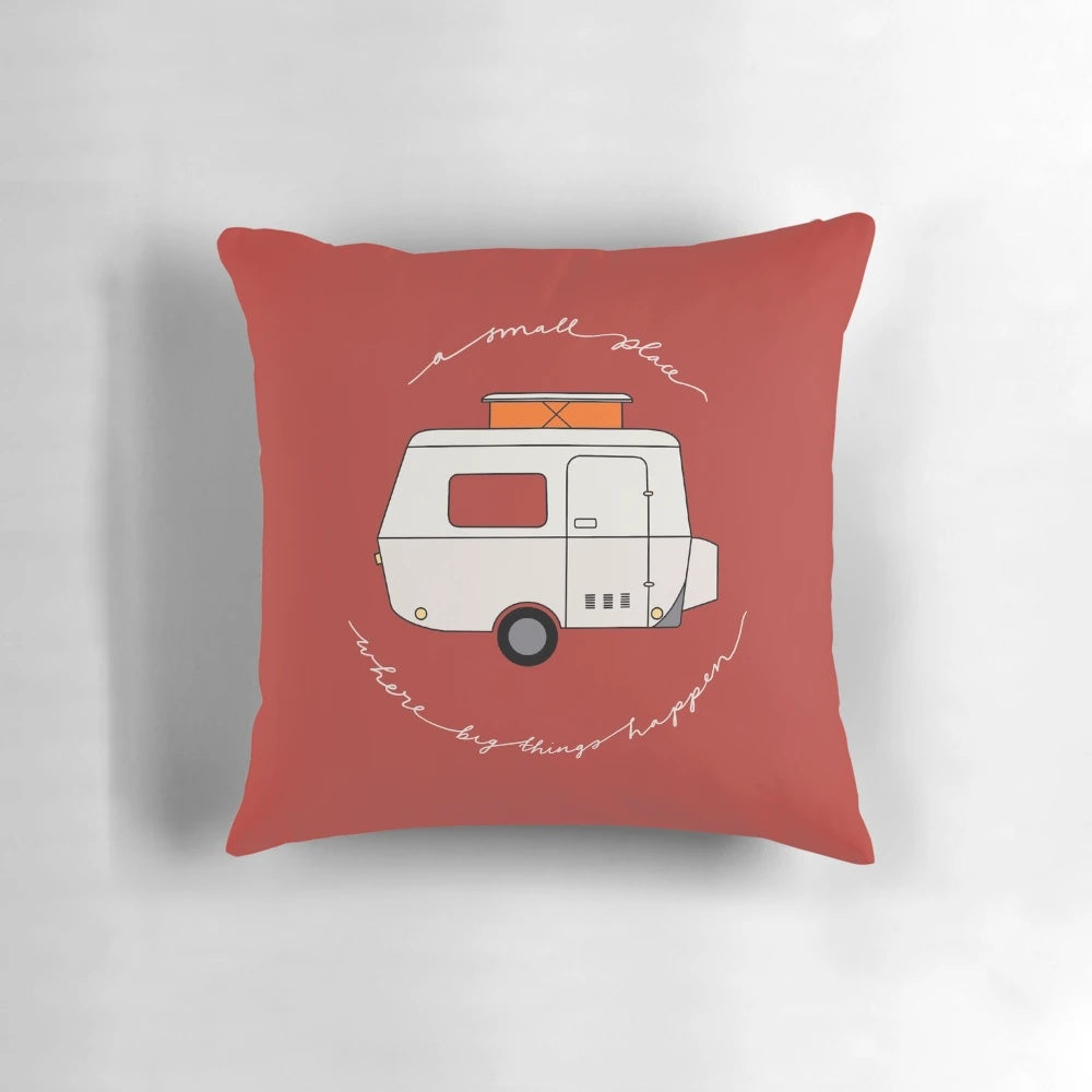 A red pillow with the text "A Small Place Where Big Things Happen