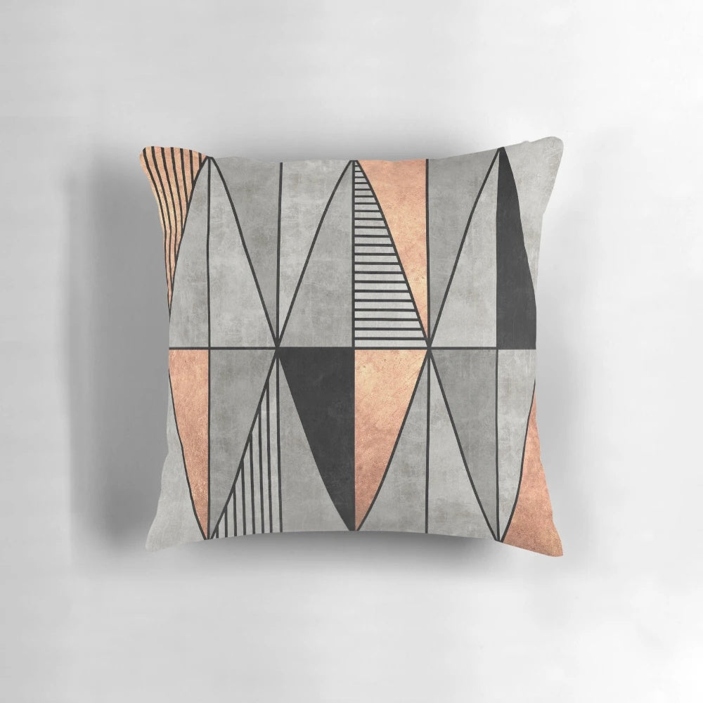 A stylish concrete and copper pillow with a geometric triangle pattern, perfect for modern home decor.