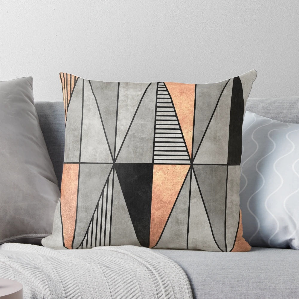 A stylish concrete and copper pillow with a geometric triangle pattern, perfect for modern home decor.