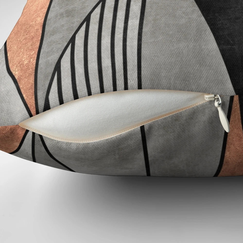 A stylish concrete and copper pillow with a geometric triangle pattern, perfect for modern home decor.