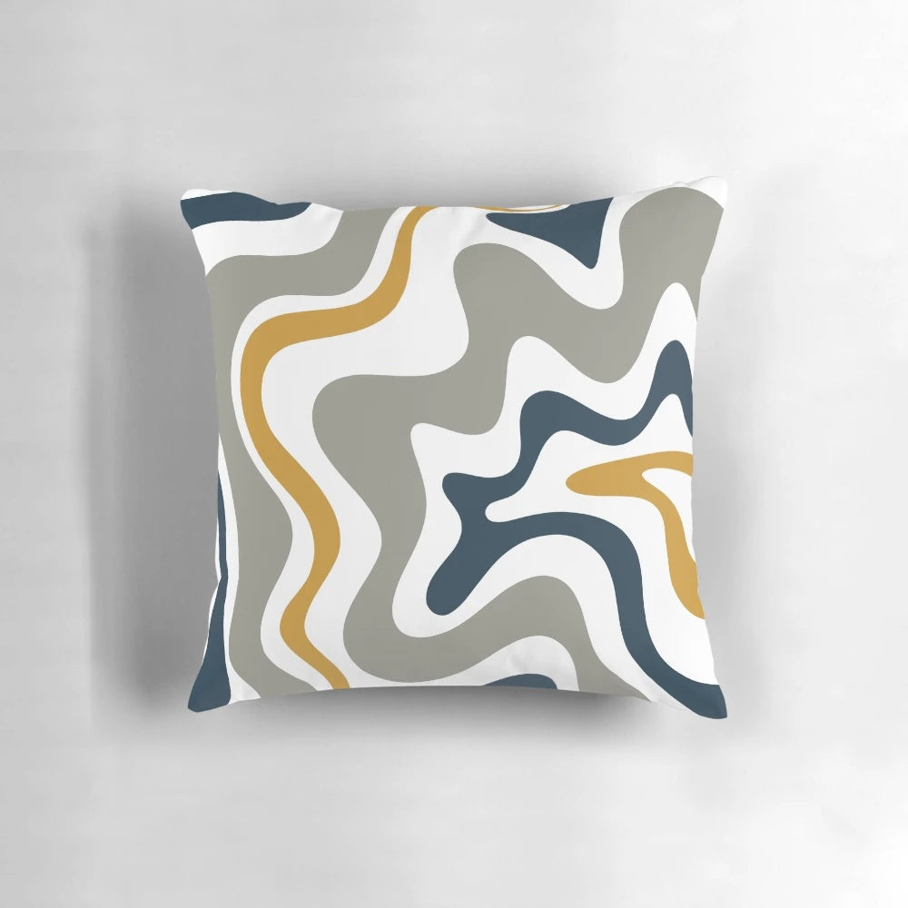 Contemporary abstract patterned pillow in mustard yellow, navy blue, and grey tones.