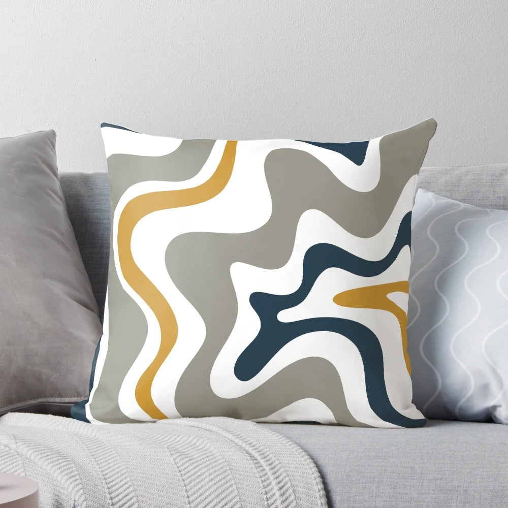 Contemporary abstract patterned pillow in mustard yellow, navy blue, and grey tones.